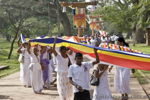 Some kind of procession with a very long flag