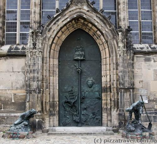 Portal of the St. John's Church. The bronze composition reminds of the destruction and reconstruction of Magdeburg during and after the World War II.